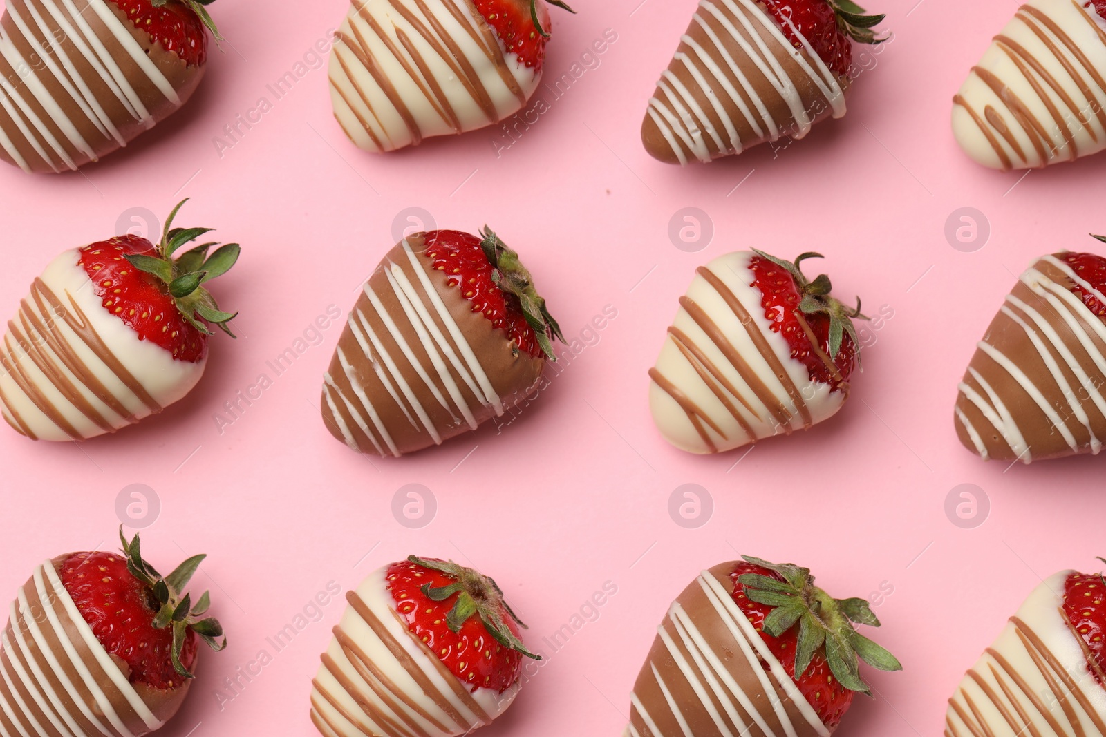 Photo of Delicious chocolate covered strawberries on pink background, flat lay