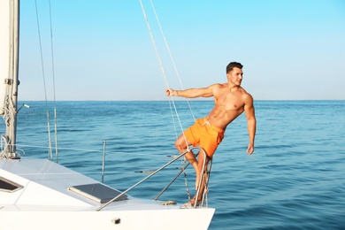 Photo of Young man relaxing on yacht during sea trip