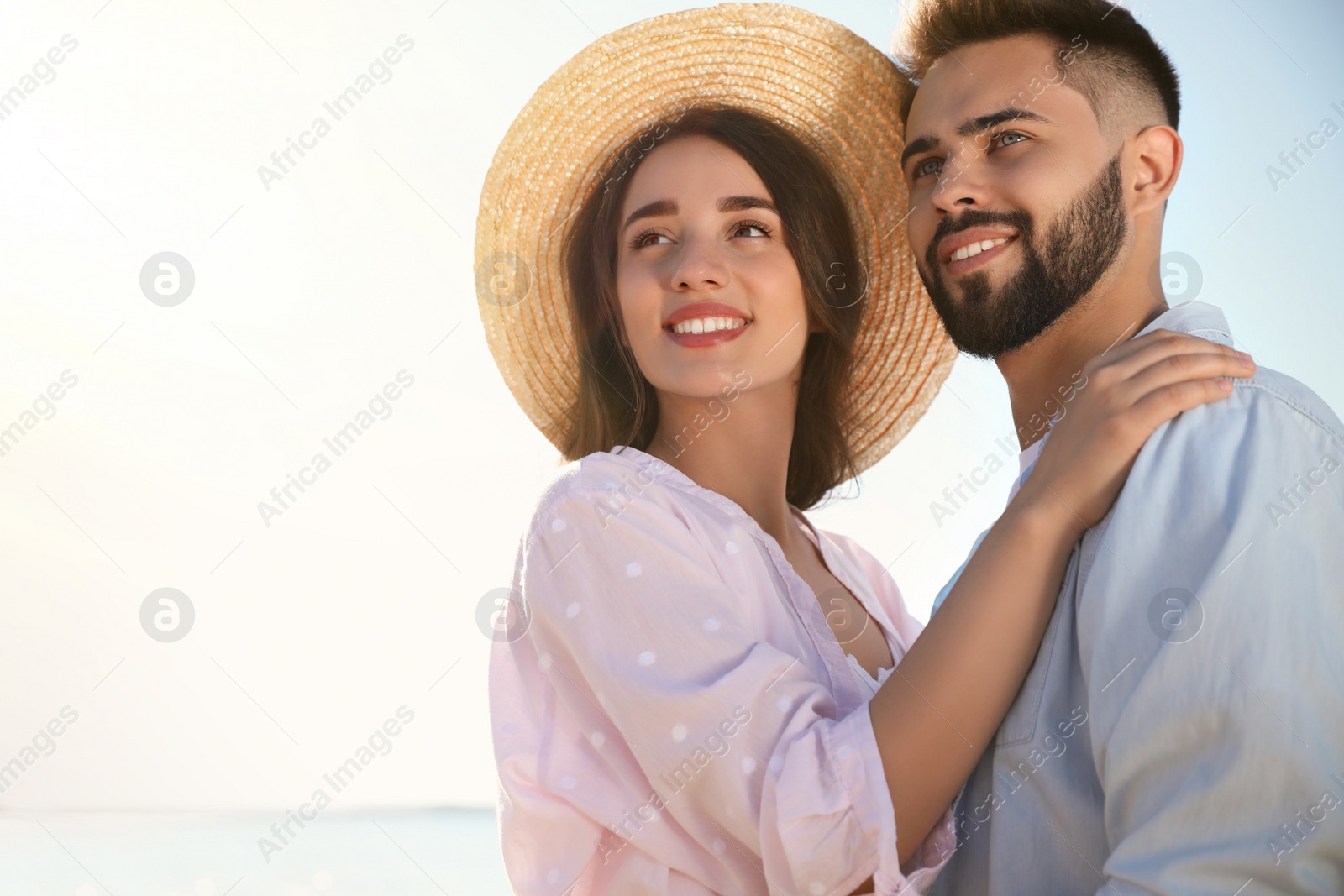 Photo of Happy young couple outdoors at beach on sunny day. Honeymoon trip