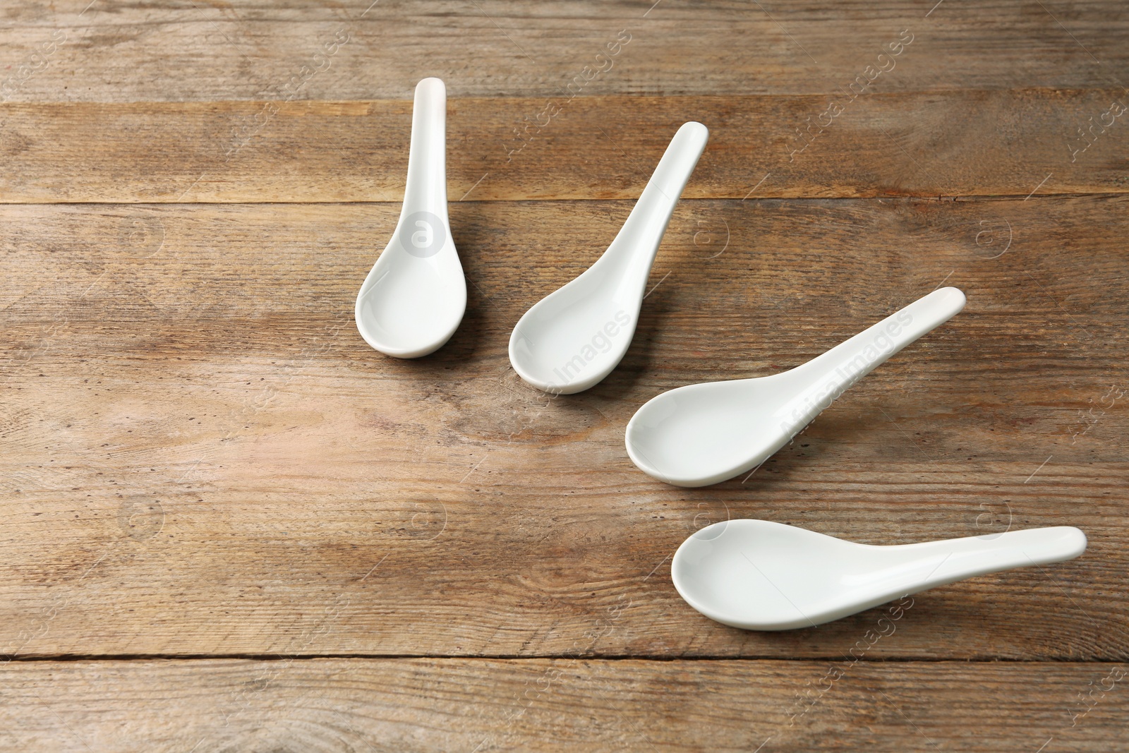 Photo of Miso soup spoons on wooden table. Space for text