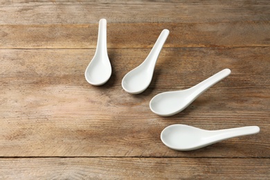 Photo of Miso soup spoons on wooden table. Space for text