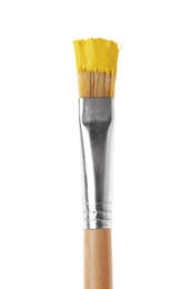 Photo of Brush with yellow paint on white background