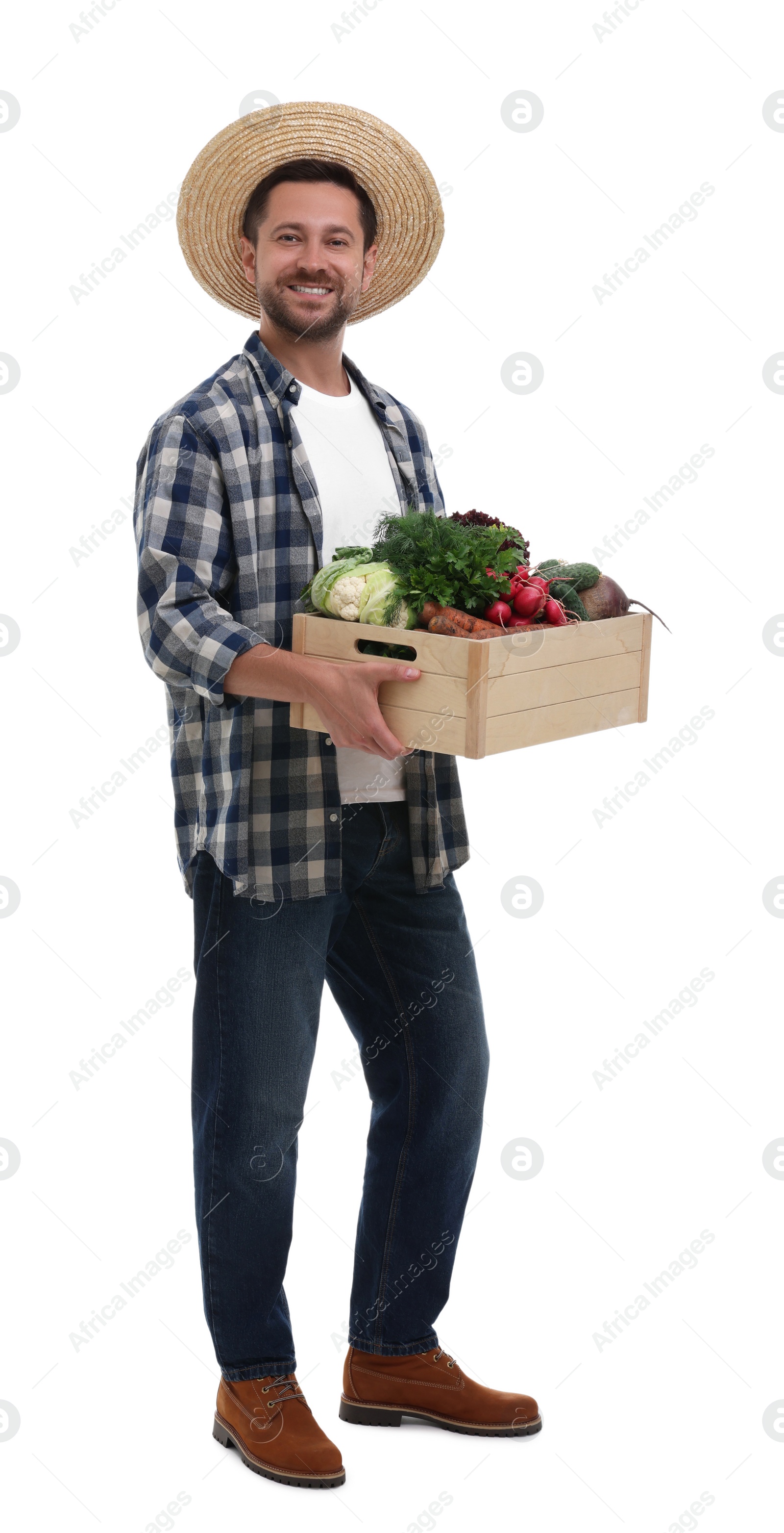 Photo of Harvesting season. Happy farmer holding wooden crate with vegetables on white background