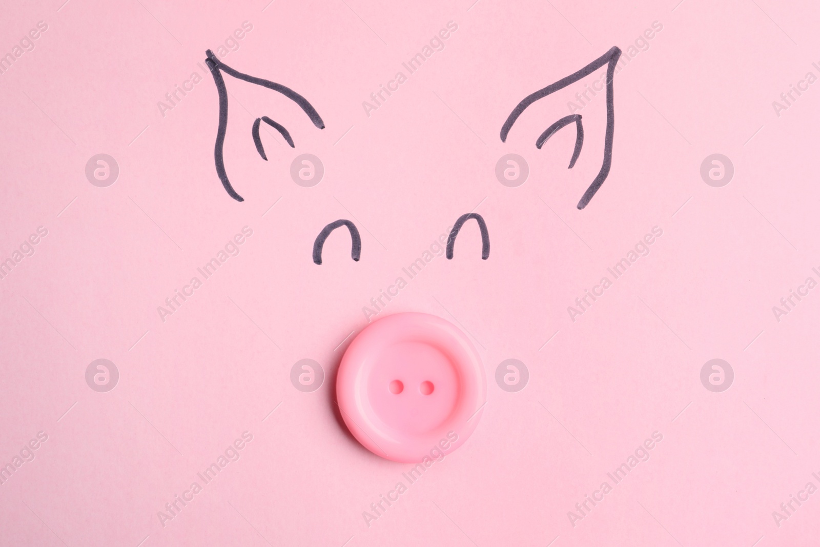 Photo of Piggy face with sewing button on pink background, top view