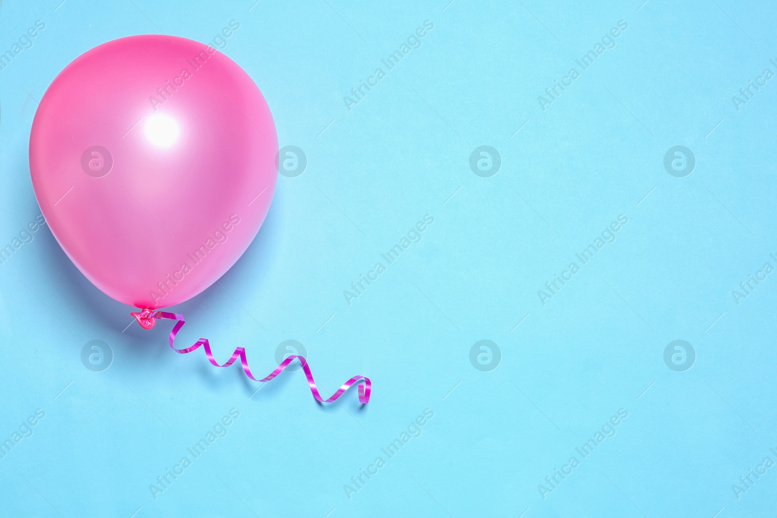 Photo of Bright balloon on color background, top view with space for text. Party time