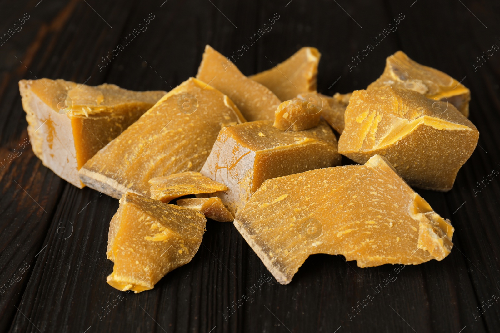 Photo of Natural organic beeswax blocks on wooden table