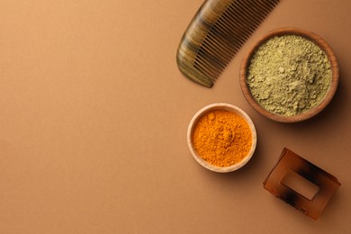 Photo of Flat lay composition with henna and turmeric powder on coral background, space for text. Natural hair coloring