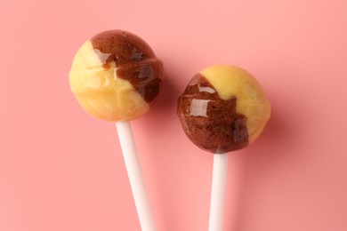 Tasty lollipops on pink background, flat lay