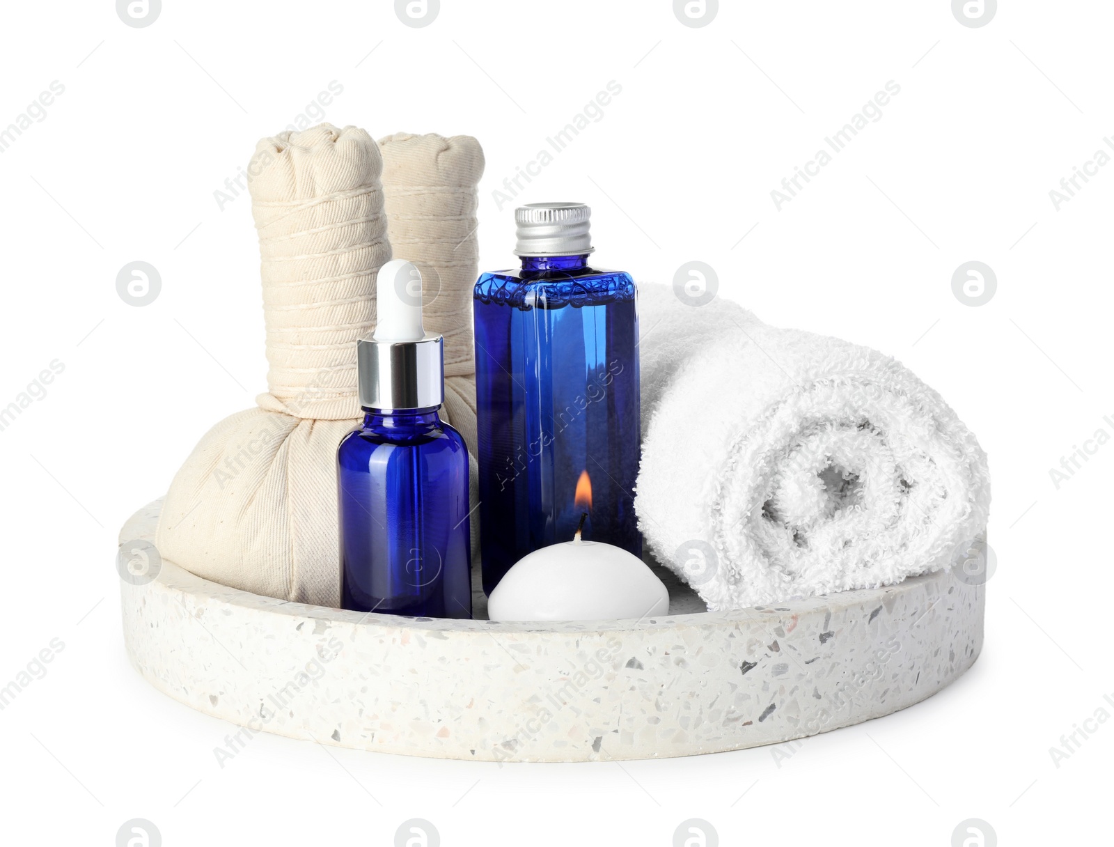 Photo of Spa composition. Bottles of cosmetic products, towel, herbal bags and burning candle isolated on white