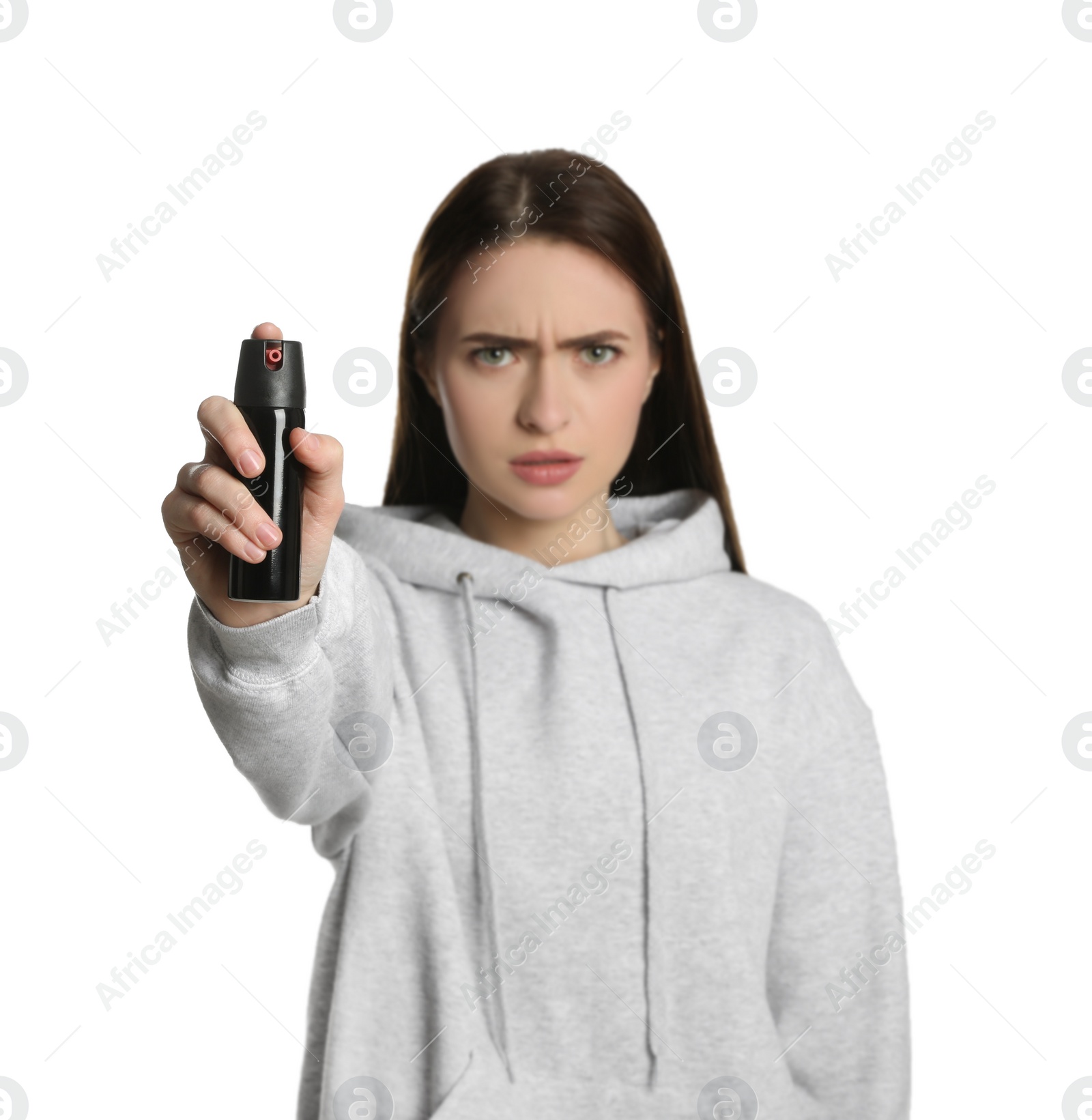 Photo of Young woman using pepper spray on white background