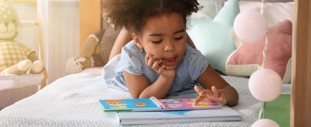 Image of African American girl reading book at home. Banner design