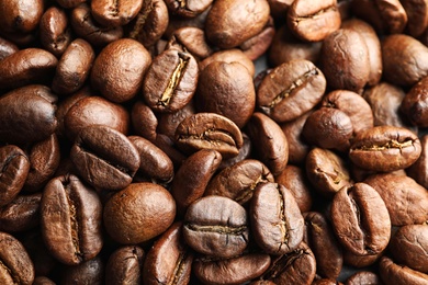 Roasted coffee beans as background, top view