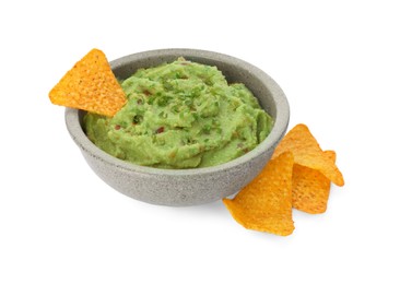 Photo of Bowl of delicious guacamole and nachos chips isolated on white
