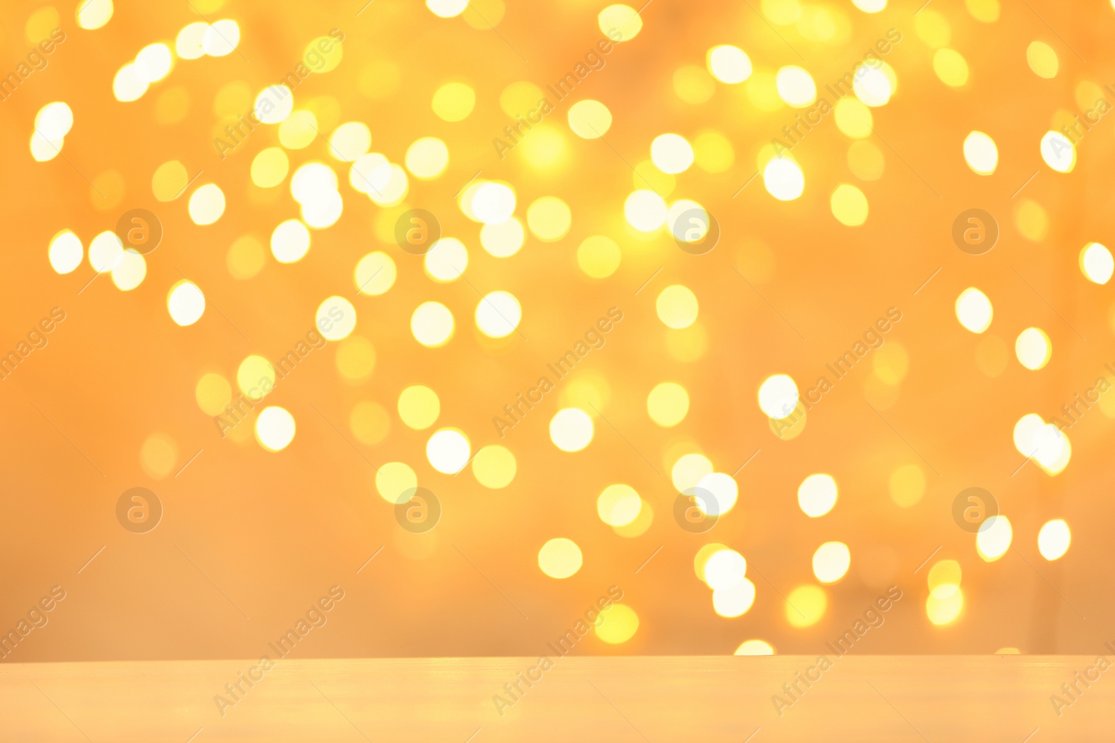 Photo of Empty table against golden bokeh background. Mockup for design