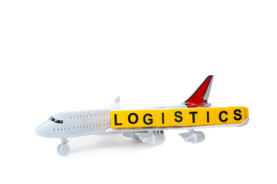 Photo of Toy plane and word LOGISTICS isolated on white. Wholesale concept