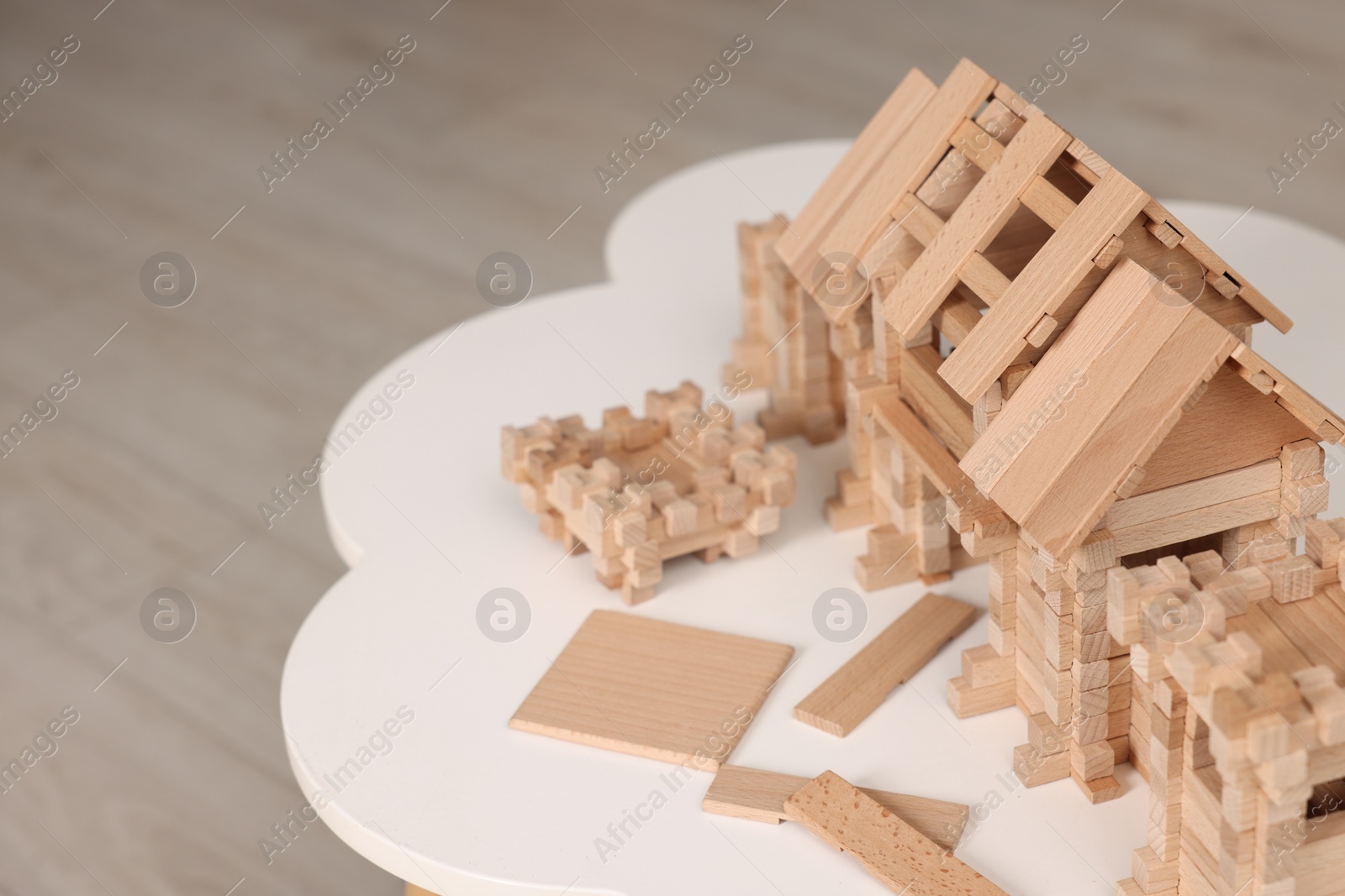 Photo of Wooden entry gate and building blocks on white table indoors, space for text. Children's toy