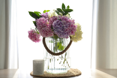 Photo of Bouquet of beautiful hydrangea flowers on table near window. Interior design