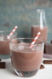 Photo of Delicious chocolate milk on white wooden table