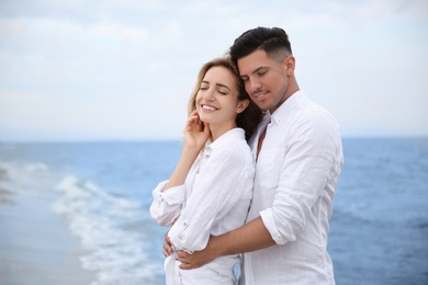 Photo of Happy couple on sea beach. Romantic walk