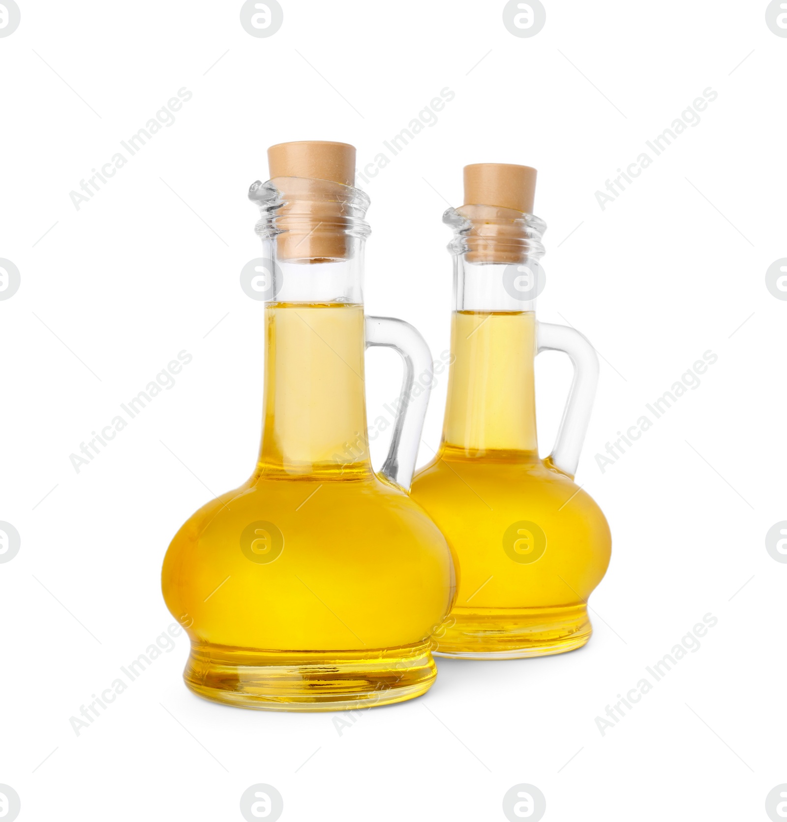 Photo of Glass jugs of cooking oil on white background