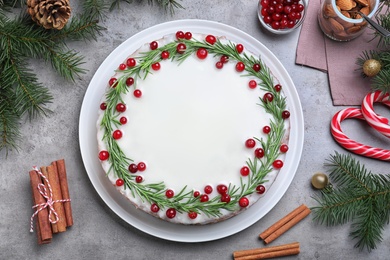 Flat lay composition with traditional Christmas cake on light grey table