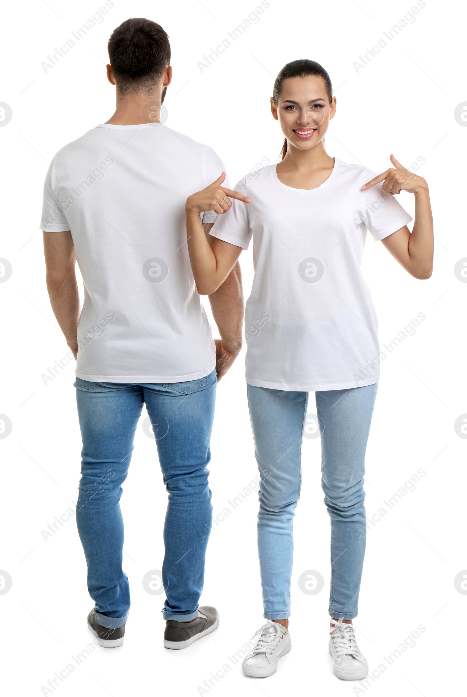 Photo of Young couple in t-shirts on white background. Mockup for design