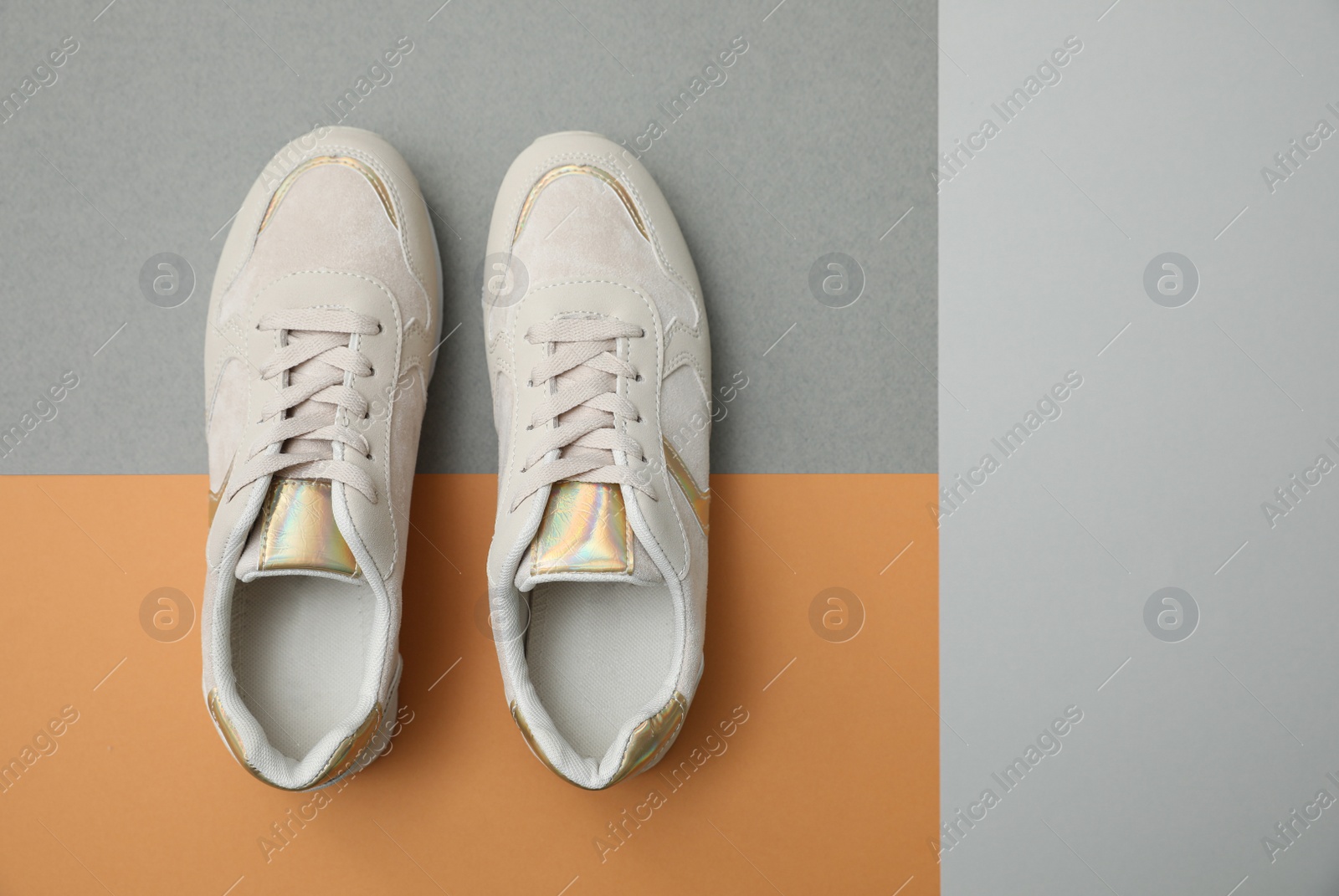 Photo of Stylish women's sneakers on color background, top view. Space for text