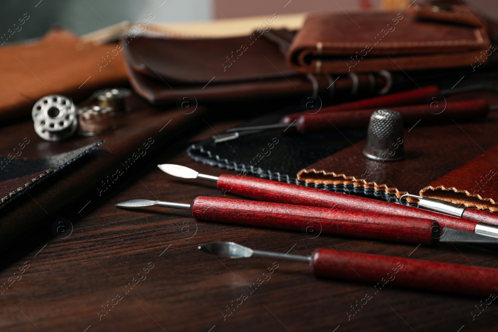 Photo of Leather samples and tools on wooden table