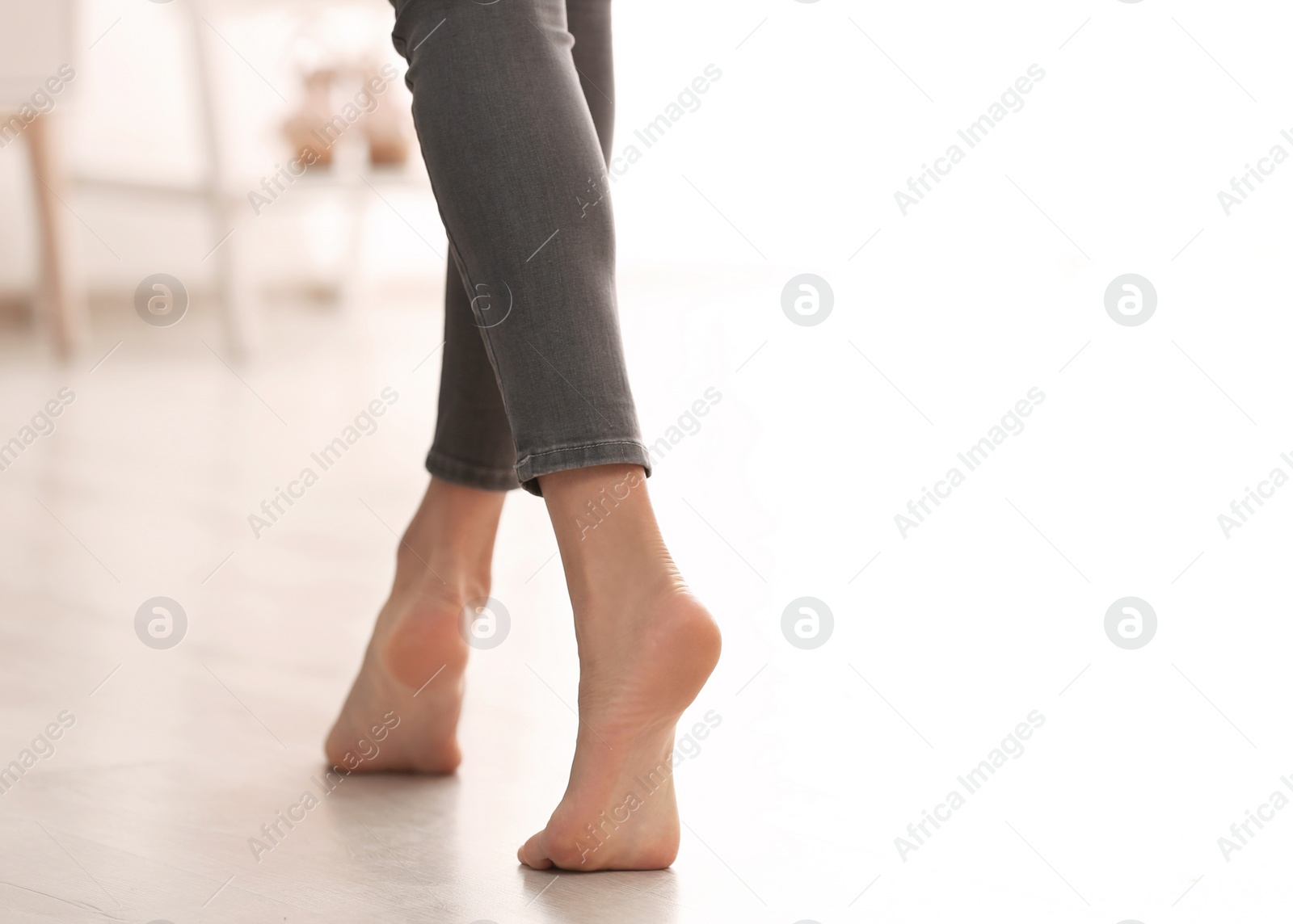 Photo of Young woman walking barefoot at home, closeup. Heating concept