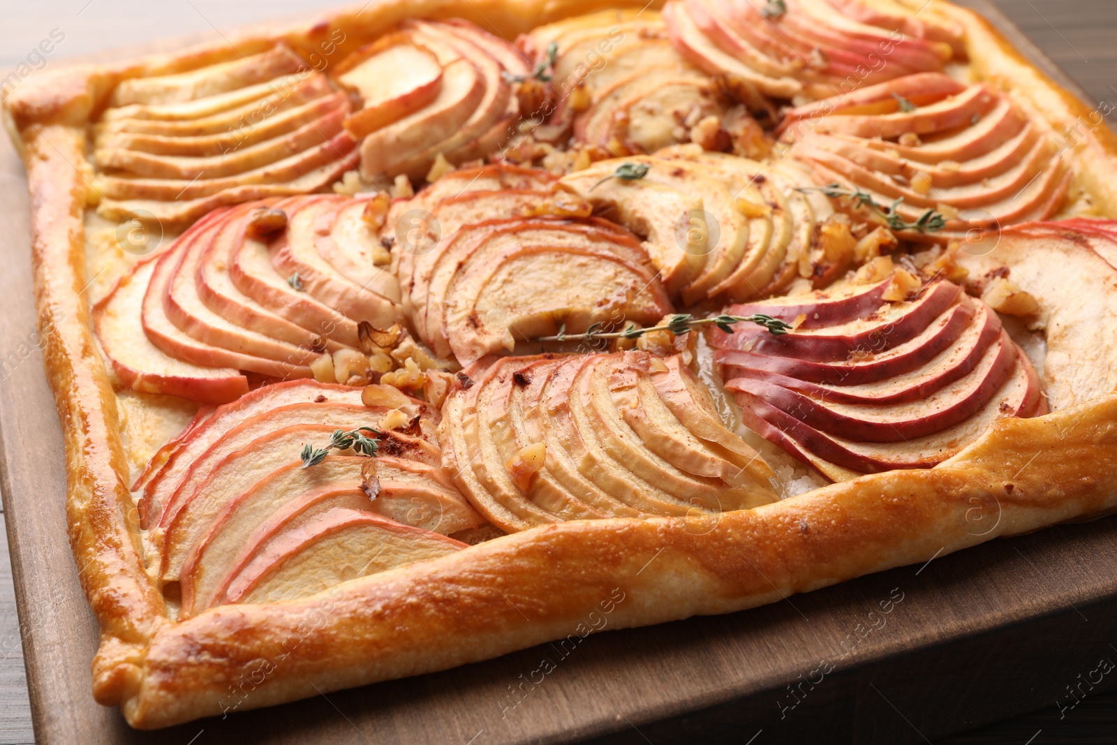 Photo of Freshly baked apple pie with nuts on table, closeup