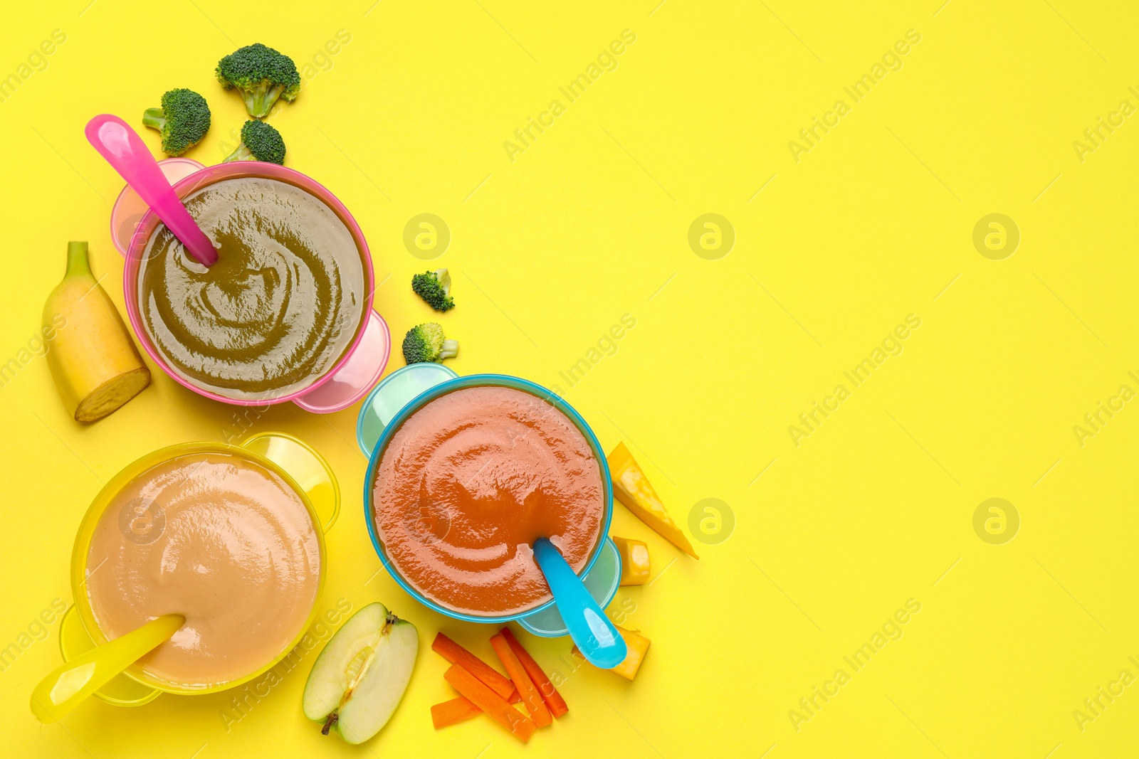 Photo of Healthy baby food and ingredients on yellow background, flat lay. Space for text