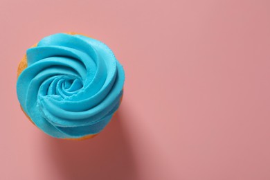 Photo of Delicious cupcake with bright cream on pink background, top view. Space for text