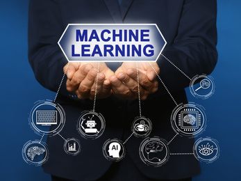 Man demonstrating machine learning model with linked icons on blue background, closeup