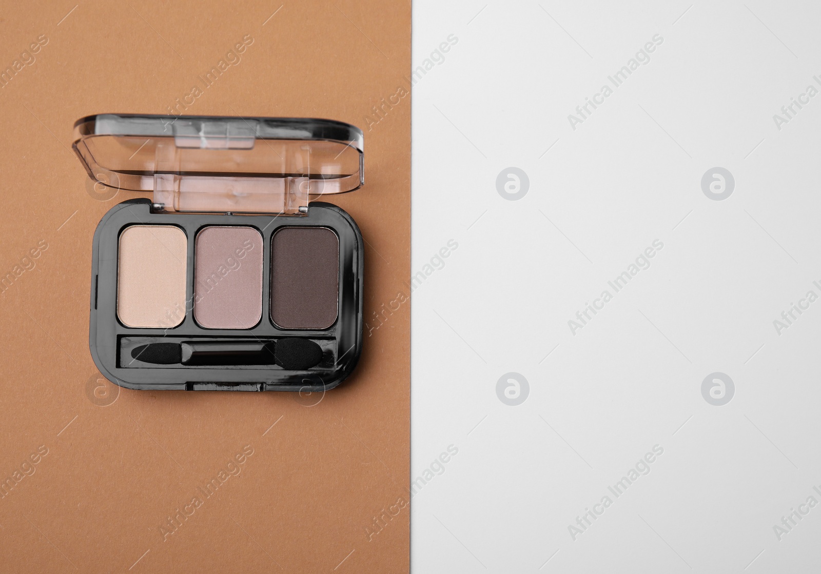 Photo of Eye shadow palette on colorful background, top view. Space for text