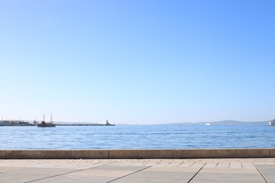 Photo of Beautiful view of embankment and calm sea with yachts on sunny day