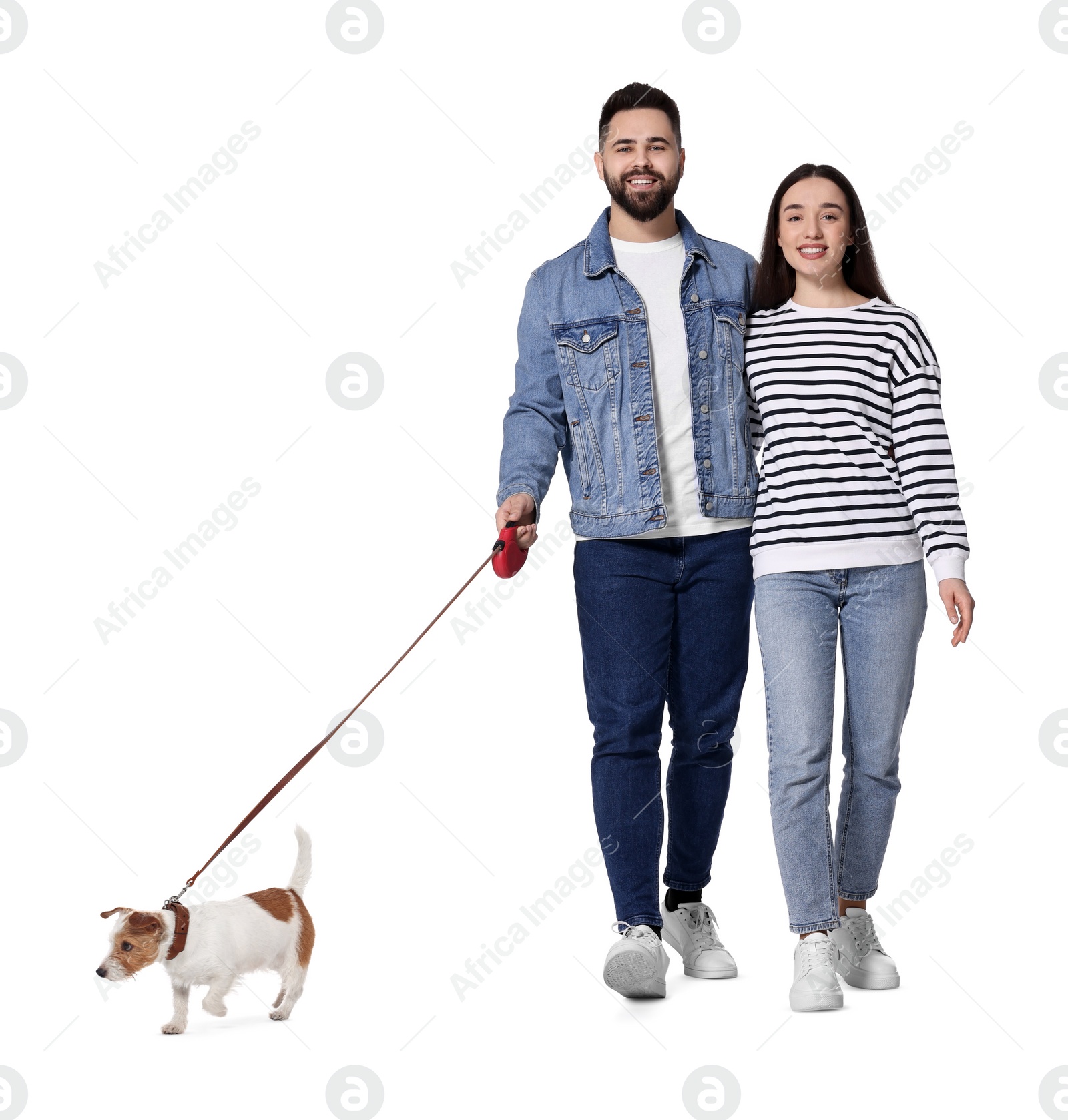 Image of Happy couple walking with dog on white background