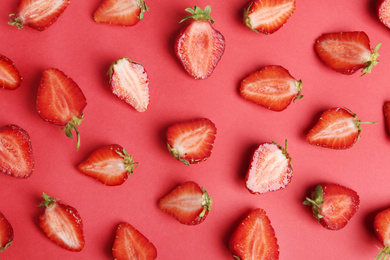 Photo of Tasty ripe strawberries on red background, flat lay