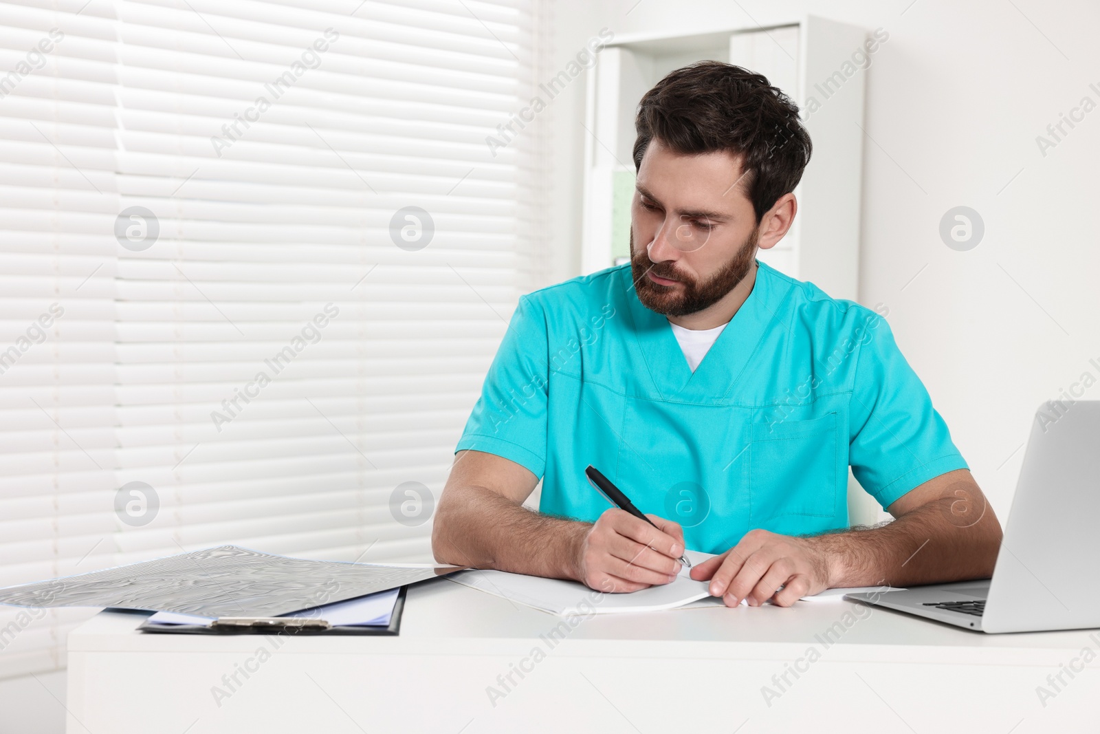 Photo of Doctor writing results from MRI scan in hospital