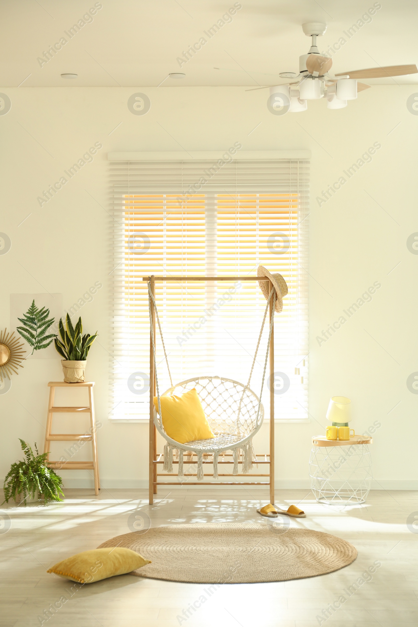 Photo of Comfortable hammock chair in stylish room. Home interior