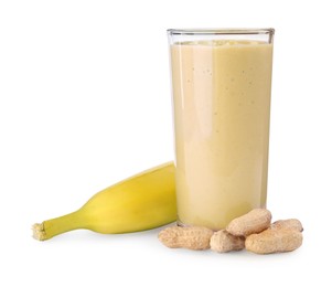 Photo of Glass of tasty banana smoothie with peanuts and fresh fruit on white background