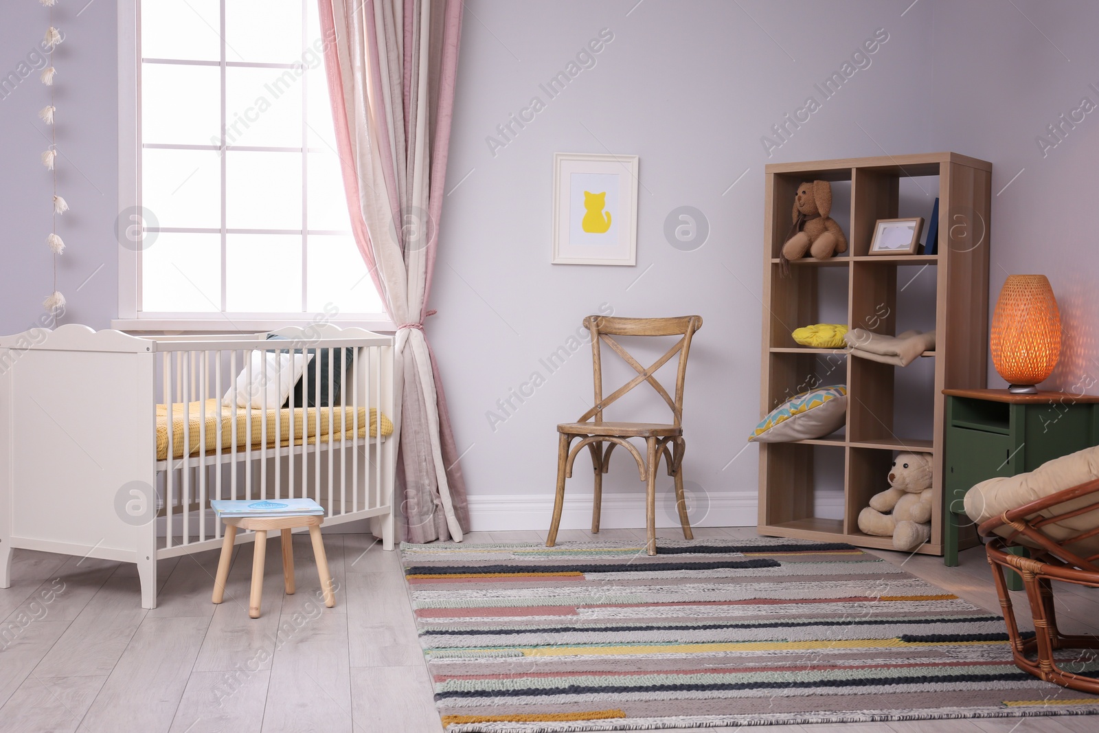 Photo of Baby room interior with comfortable crib