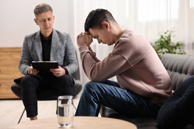 Photo of Professional psychotherapist working with patient in office