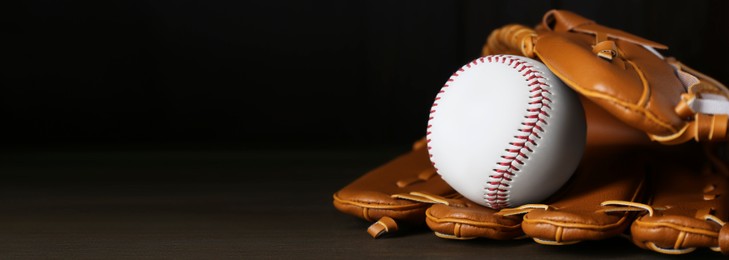 Image of Leather baseball glove with ball on wooden table, space for text. Banner design