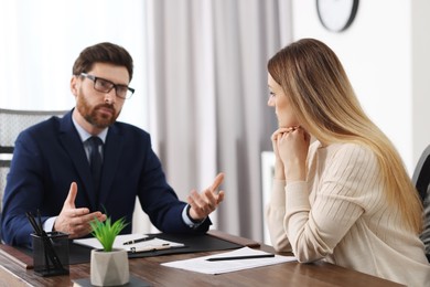 Woman having meeting with lawyer in office, selective focus