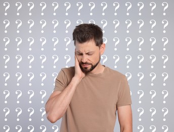 Amnesia. Confused man and question marks on light grey background