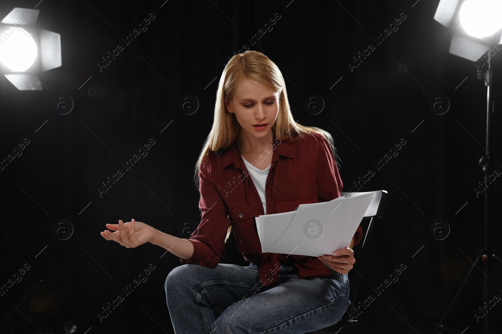 Photo of Professional actress reading her script during rehearsal in theatre