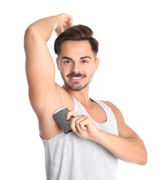 Photo of Young man using deodorant on white background