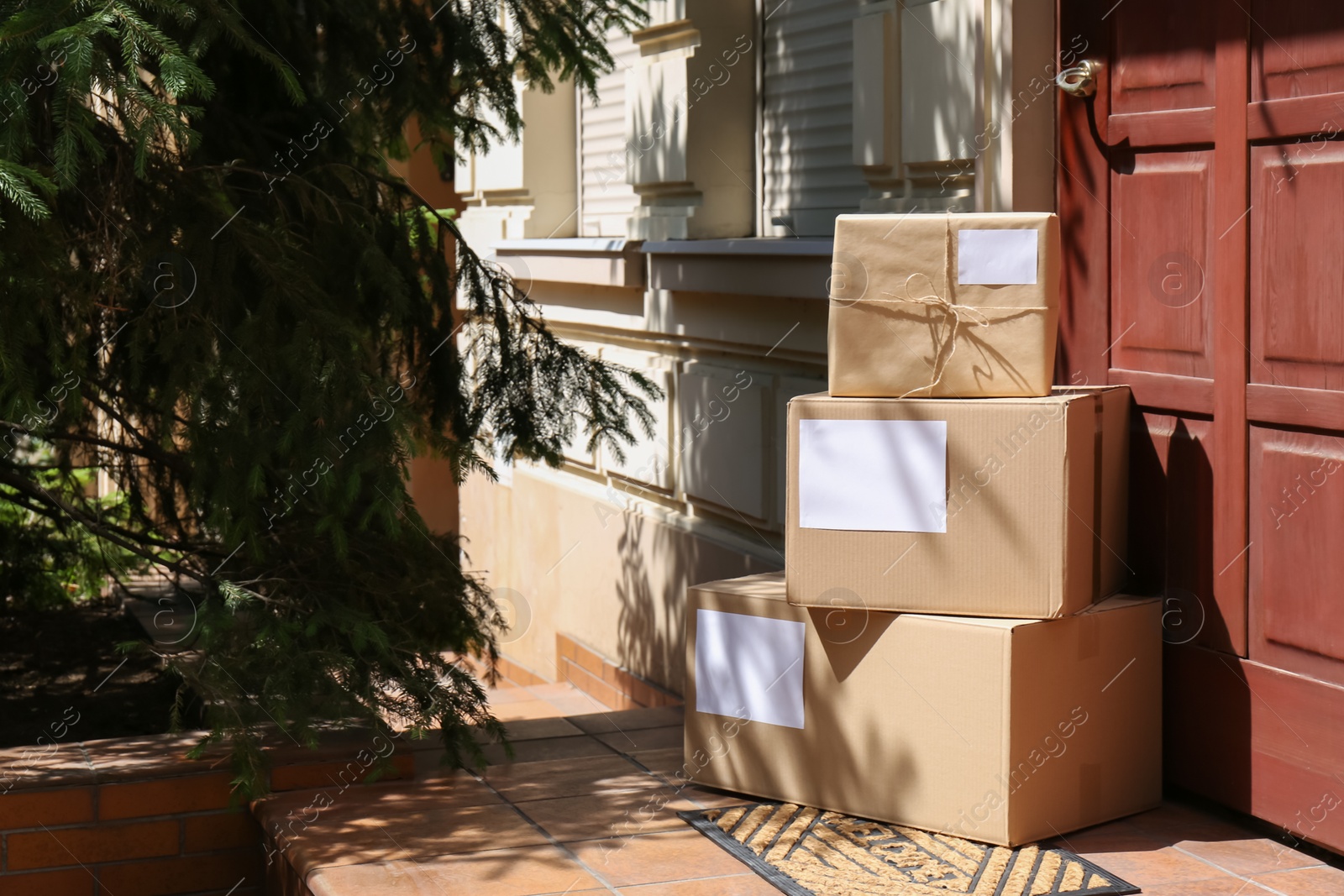 Photo of Delivered parcels on door mat near entrance