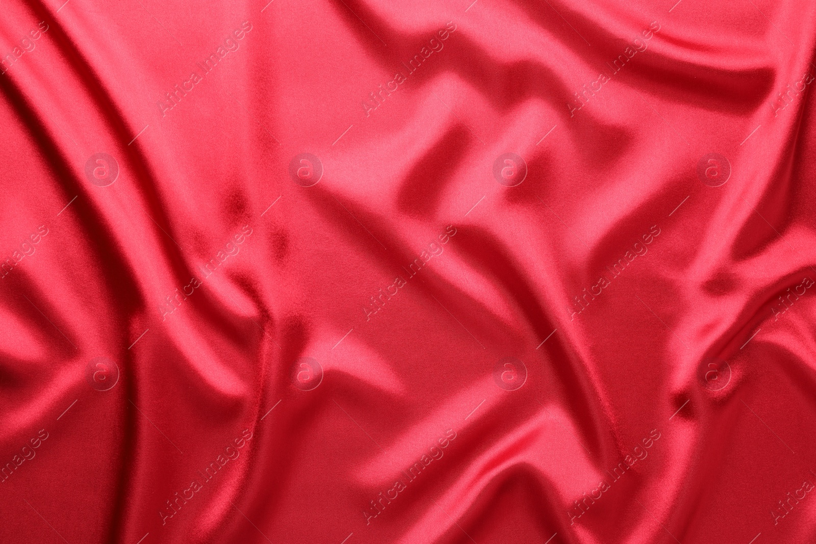 Photo of Texture of beautiful red silk fabric as background, closeup