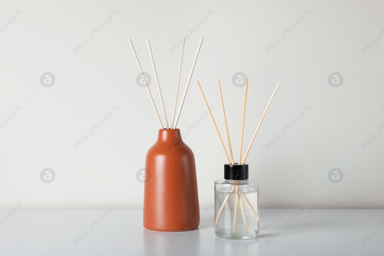 Photo of Aromatic reed air fresheners on white table